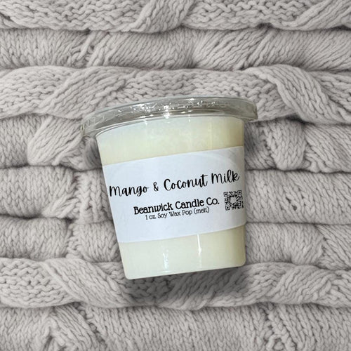 a candle sitting on top of a pile of blankets