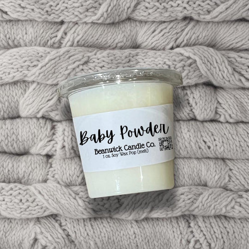 a candle sitting on top of a pile of blankets
