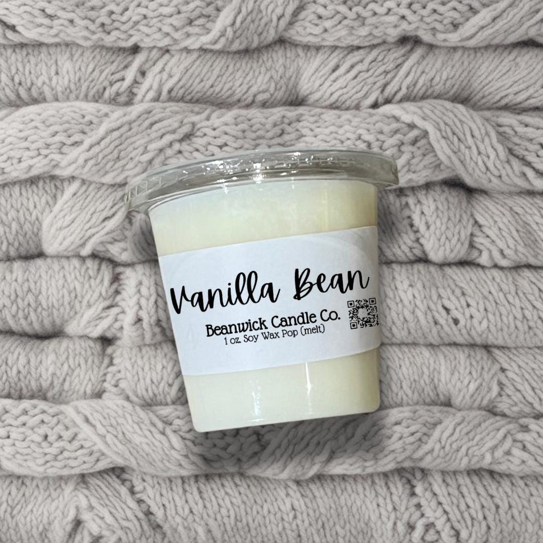a candle is sitting on a pile of blankets