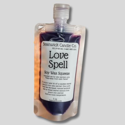 a bottle of love spell on a gray background