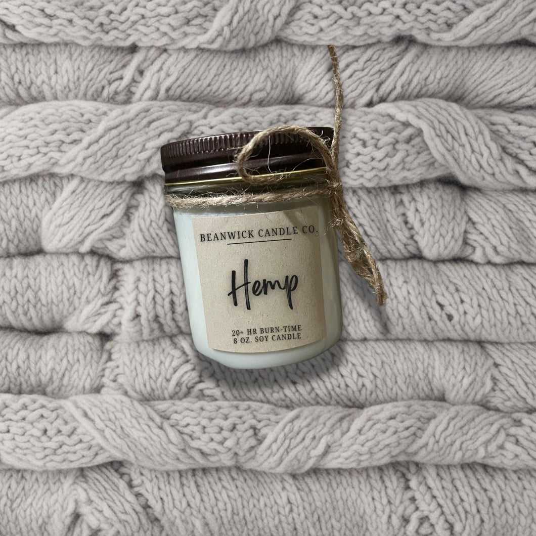 a jar of hemp sitting on top of a pile of blankets