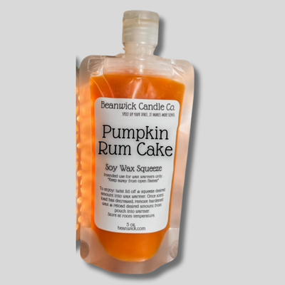 a bottle of pumpkin rum cake on a gray background