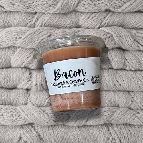 a jar of bath salts sitting on top of a pile of blankets