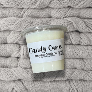 a candle sitting on top of a pile of blankets
