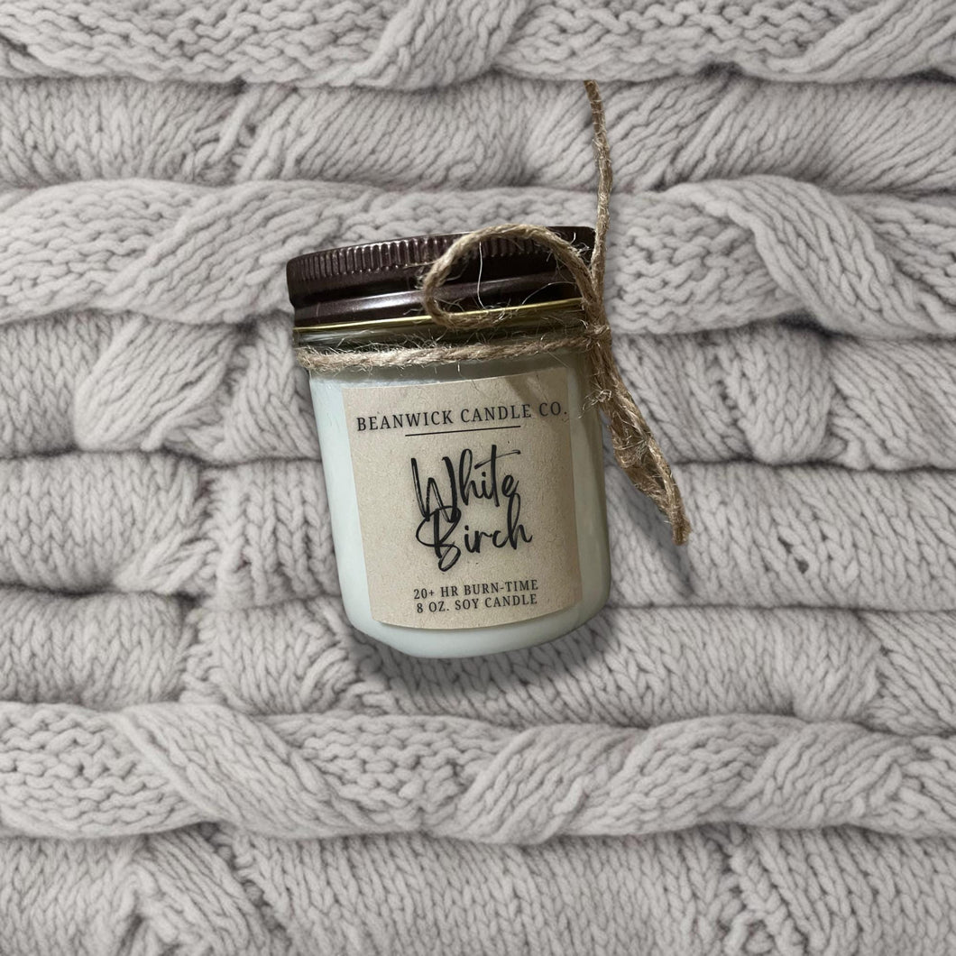 a jar of wild brush sits on a pile of blankets