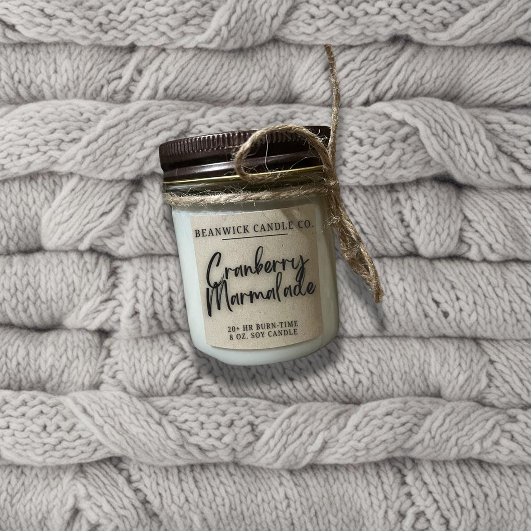 a jar of cranberry marshmallows sitting on top of a pile