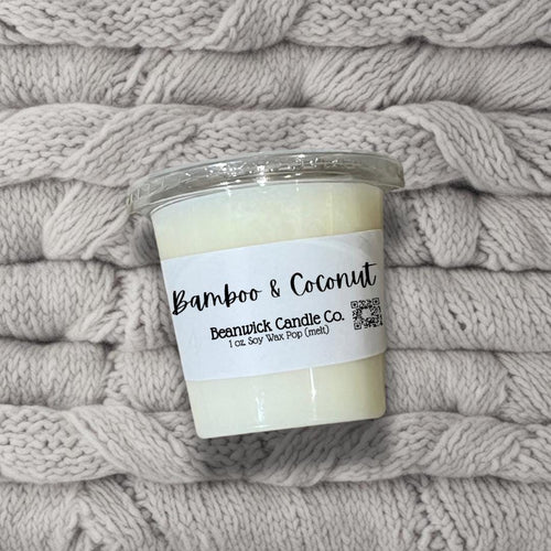 a candle is sitting on a pile of blankets