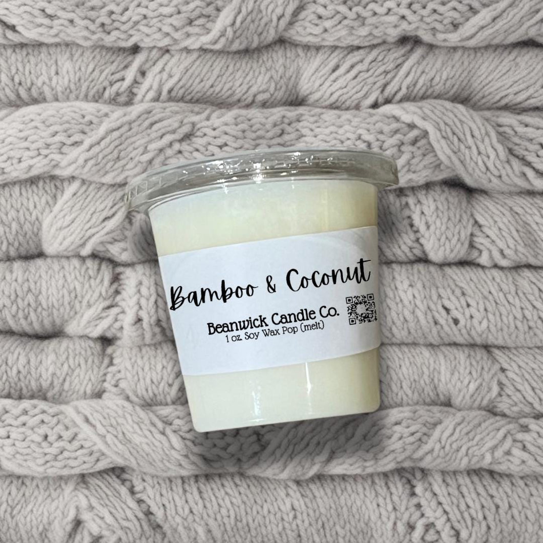 a candle is sitting on a pile of blankets