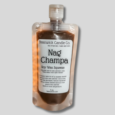 a bottle of nag champa on a gray background