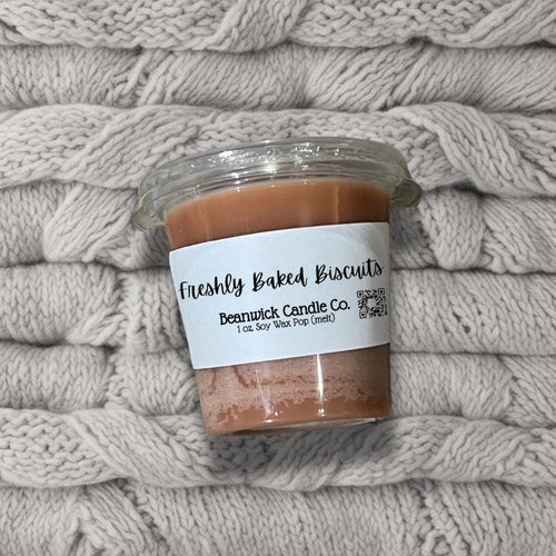 a jar of peanut butter sitting on top of a pile of blankets