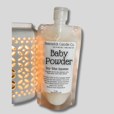 a bottle of baby powder next to a light