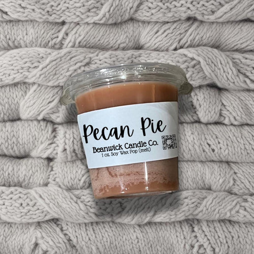 a jar of pecan pie sits on a pile of blankets