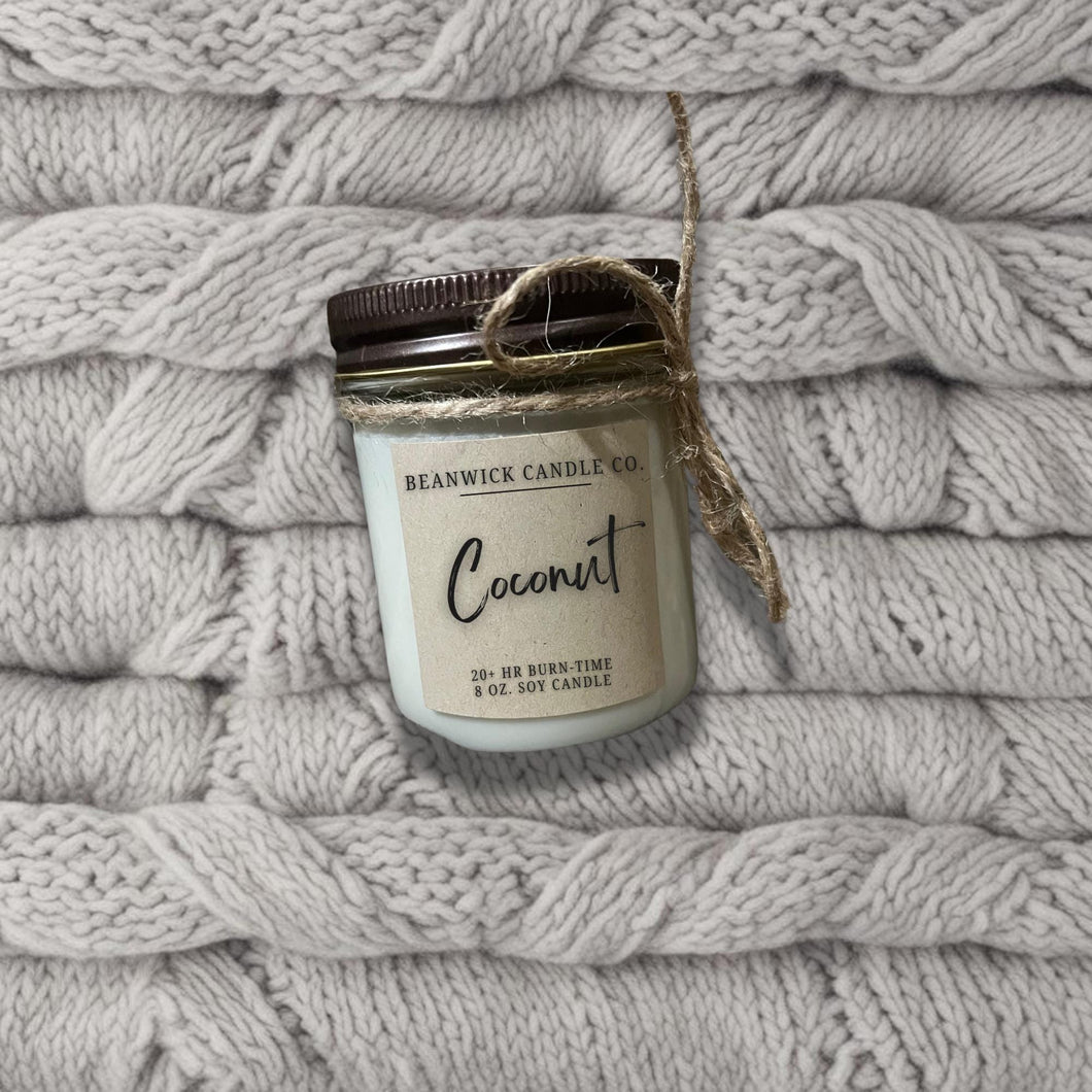 a jar of coconut sitting on top of a pile of blankets