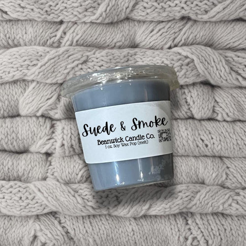 a jar of smoke sits on a pile of blankets