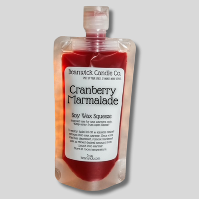 a bottle of cranberry marmalade on a gray background