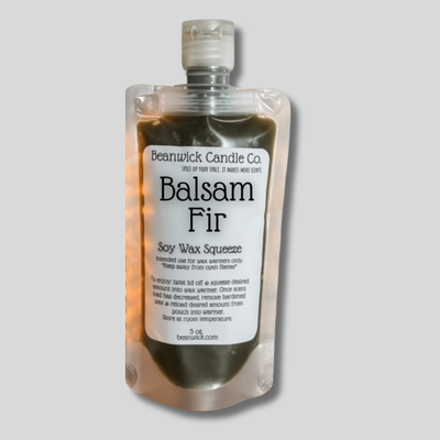 a bottle of balsam fir soap on a gray background