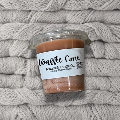 a jar of peanut butter sitting on top of a pile of blankets