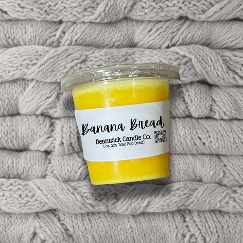 a jar of banana bread sits on a pile of blankets