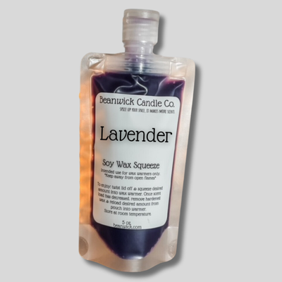 a bottle of lavender soap sitting on top of a table