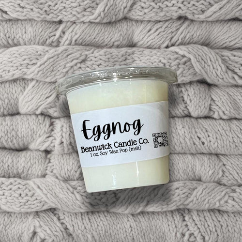 a candle sitting on top of a pile of blankets