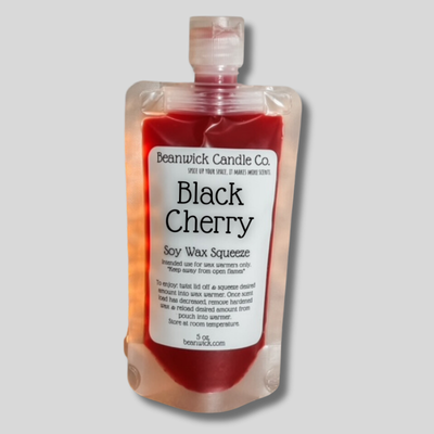 a bottle of black cherry soap on a gray background