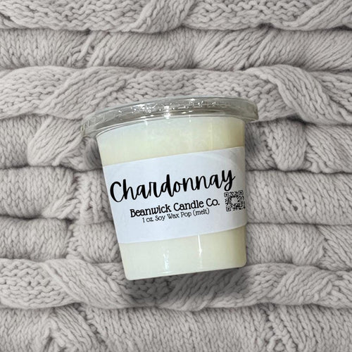 a candle sitting on top of a pile of blankets